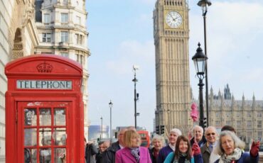 Blue Badge Tourist Guides near Red Telephone Box in London.