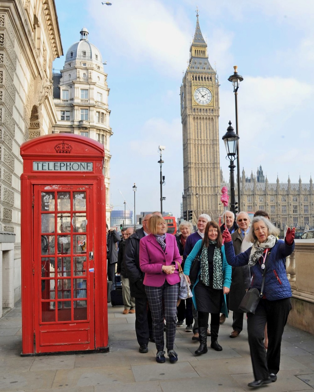 Blue Badge Tourist Guides near Red Telephone Box in London.